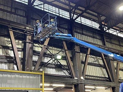 Engineer in crane inspecting overhead crane girder
